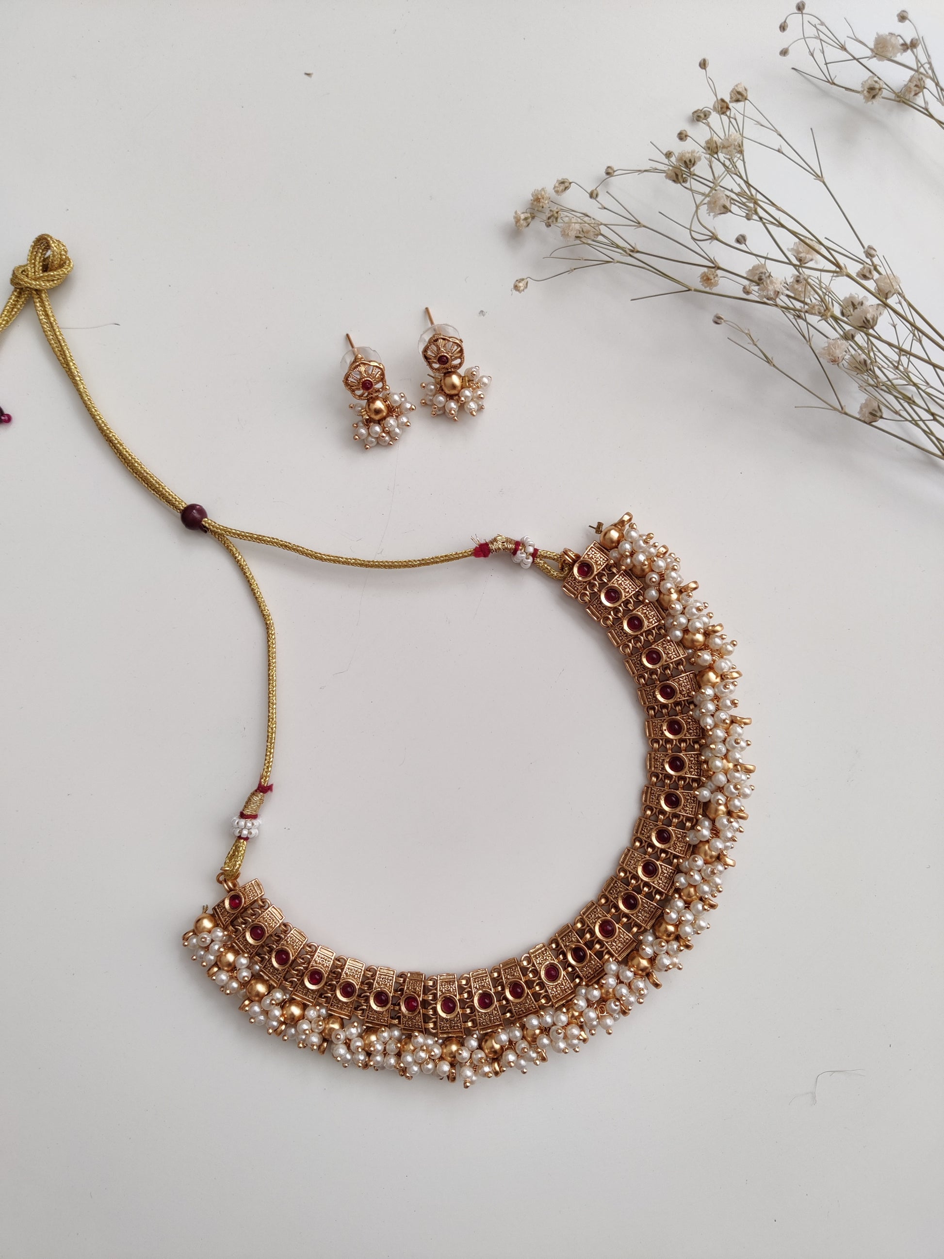 Elegant gold-tone temple necklace set in metal alloy shown to highlight refined craftsmanship
