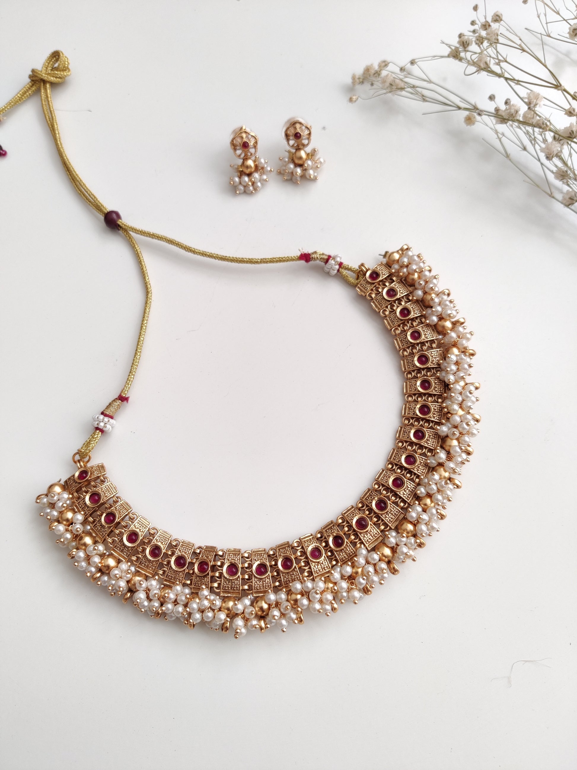 Elegant gold-tone temple necklace set in metal alloy shown to highlight refined craftsmanship