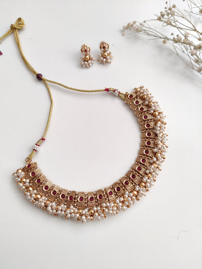 Elegant gold-tone temple necklace set in metal alloy shown to highlight refined craftsmanship
