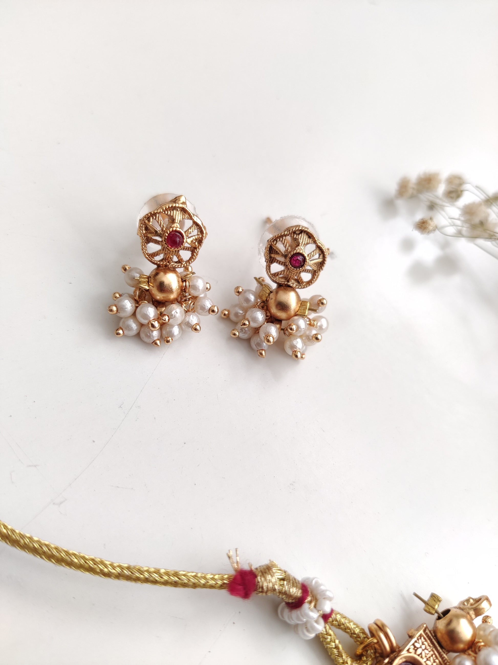 Elegant gold-tone temple necklace set in metal alloy shown to highlight refined craftsmanship