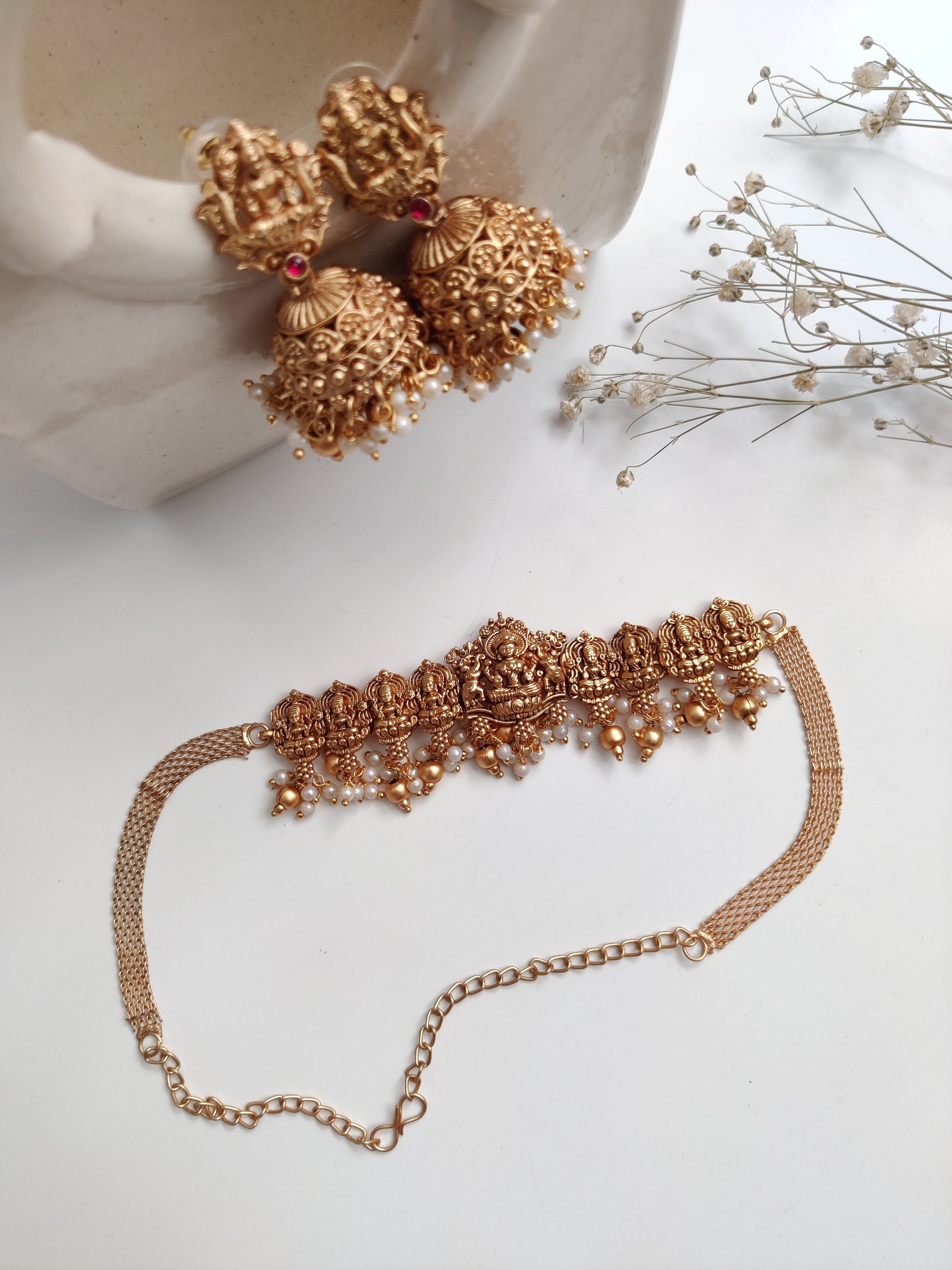 Distinctive temple necklace set blending bronze and gold tones, photographed to emphasize artisanal details