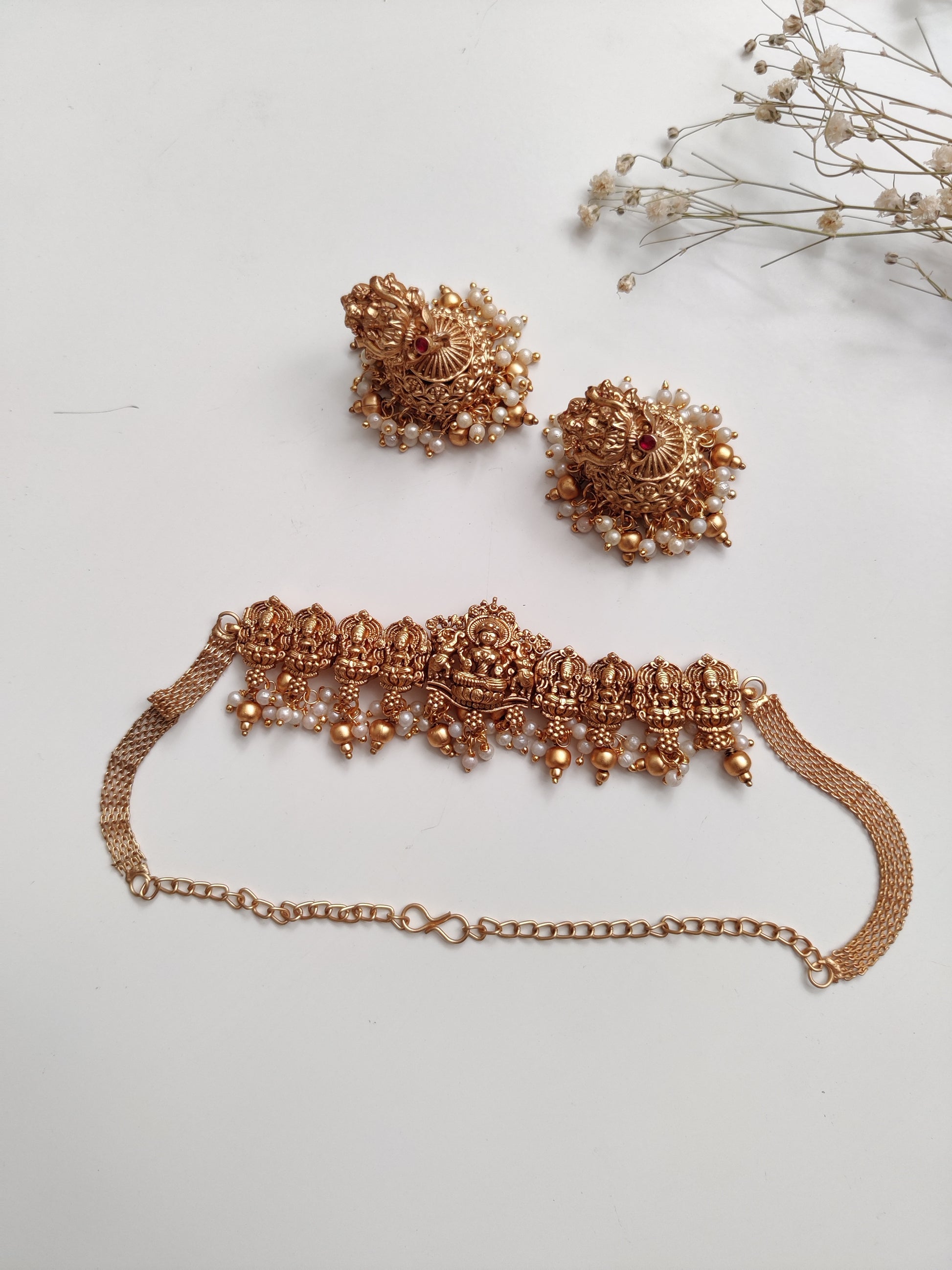 Distinctive temple necklace set blending bronze and gold tones, photographed to emphasize artisanal details