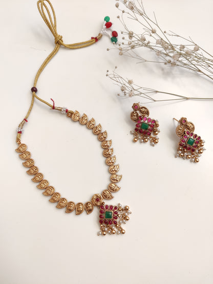 Majestic gold-tone temple necklace set in metal alloy featured to highlight intricate design and shine