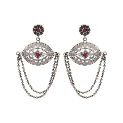 Silver-tone, traditional brass stud earrings shown on dark background
