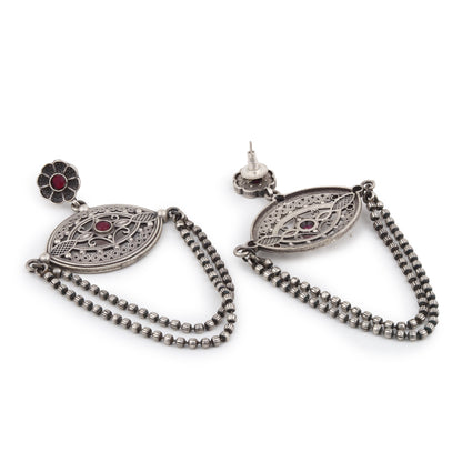 Silver-tone, traditional brass stud earrings shown on dark background