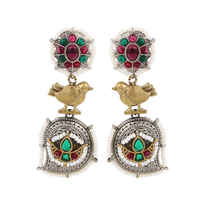 Red and silver stud earrings, Rimisha by Naitri, festive design on display.
