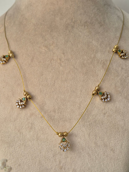 Decorative necklace set with green gemstones golden plated jewelery set minimal and antique design by naitri.in