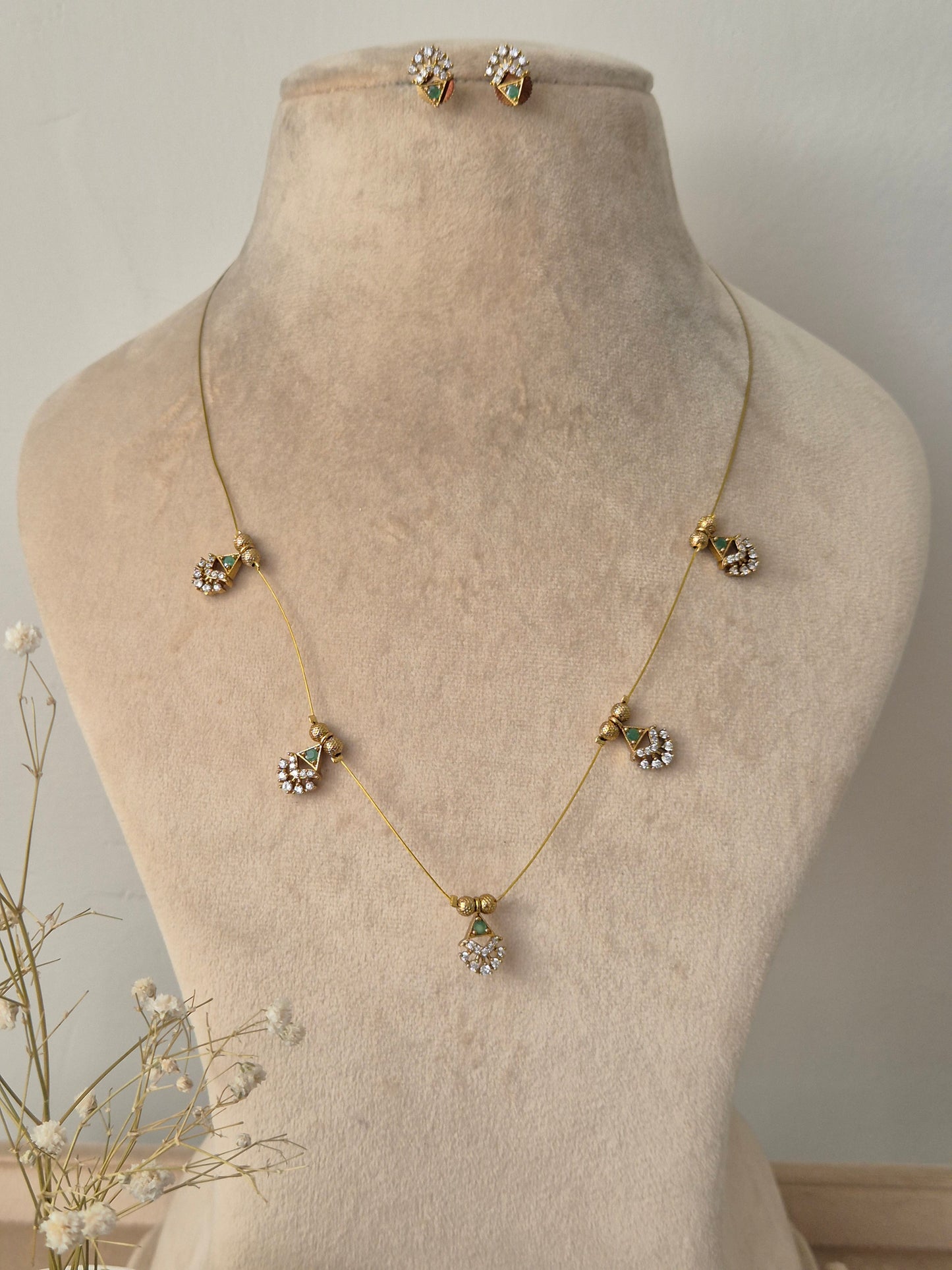 Delicate necklace with floral pendants invisible chain light weight elegant and minimal jewellery set by naitri