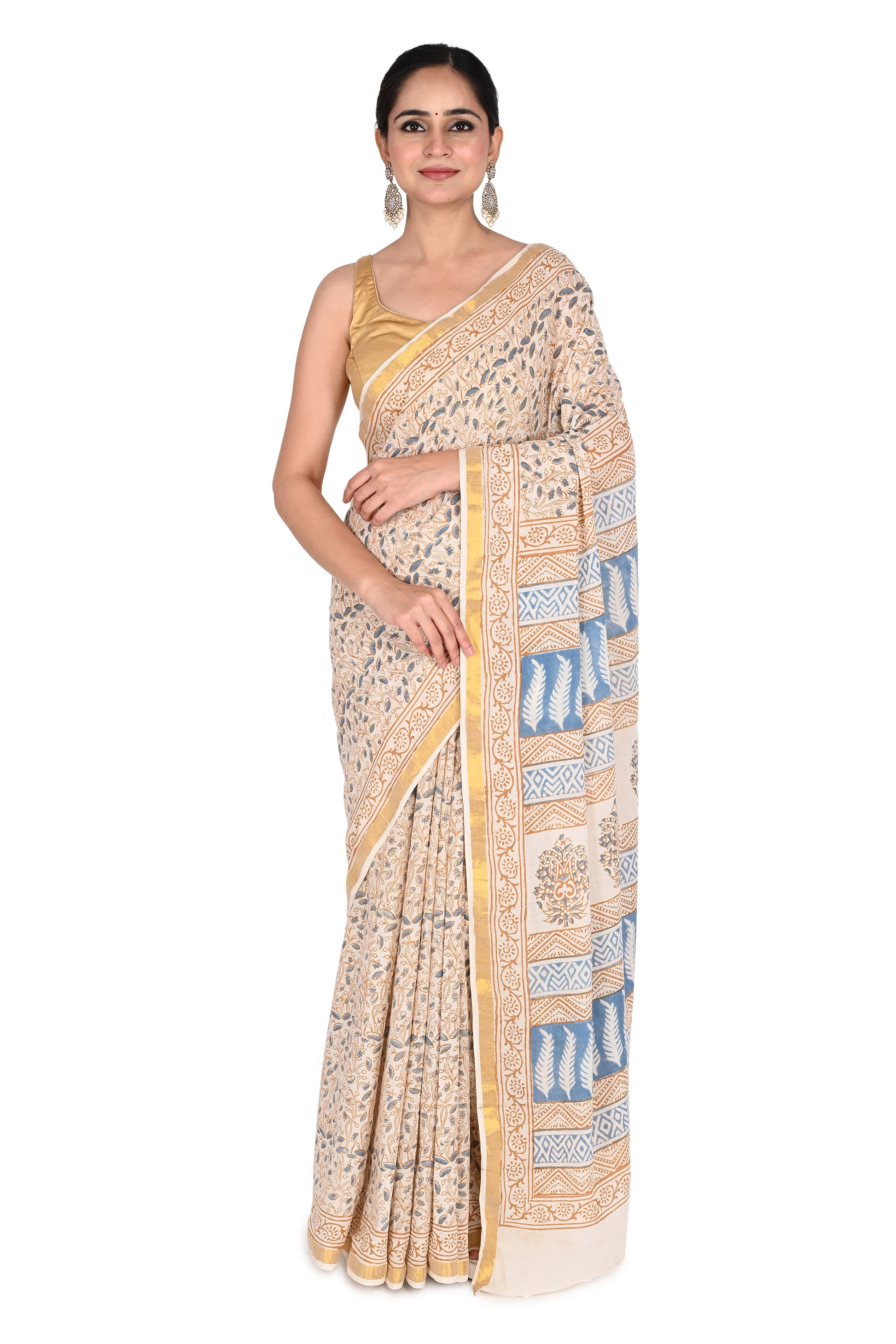 Woman wearing the Indrakshi hand block printed cotton saree in beige and white with blue floral and geometric motifs by naitri.in