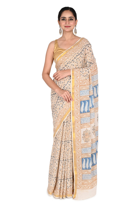 Woman wearing the Indrakshi hand block printed cotton saree in beige and white with blue floral and geometric motifs by naitri.in