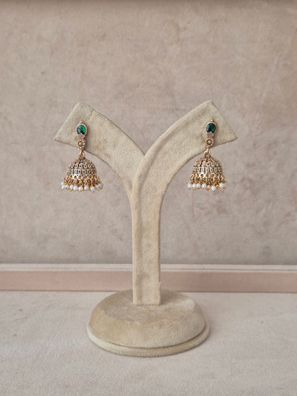 A pair of traditional Indian gold jhumka earrings with green stone accents and white pearl bead drops, by naitri.in