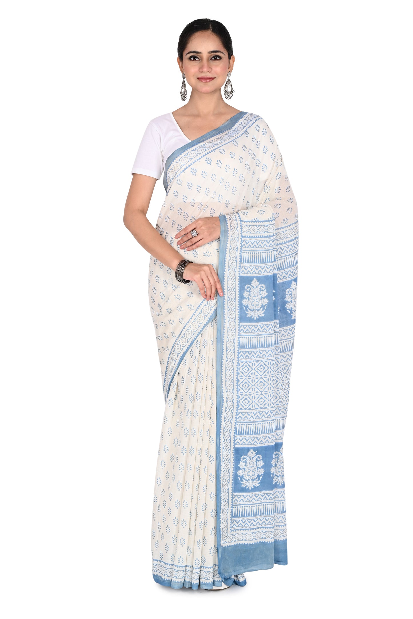 Woman wearing a white and blue Inya hand block printed cotton saree with a matching blouse by naitri.in