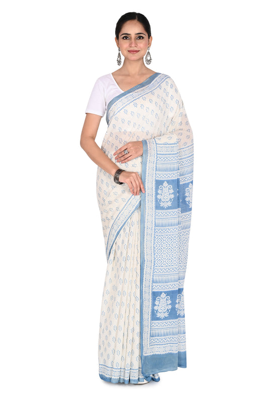 Woman wearing a white and blue Inya hand block printed cotton saree with a matching blouse by naitri.in