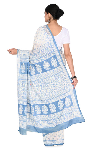 Model showcasing a classic drape of a white cotton saree with a blue floral border and printed blouse piece by naitri.in
