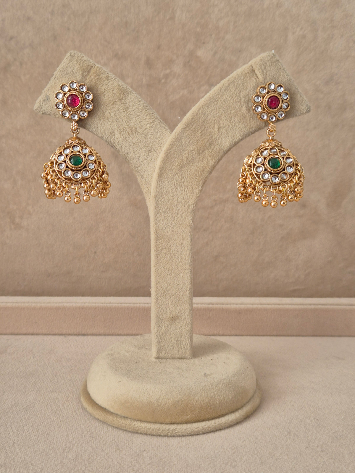 Gold-plated stone and pearl jhumka earrings ethnic jhumka earrings with stone and pearl detailing by Naitri.in