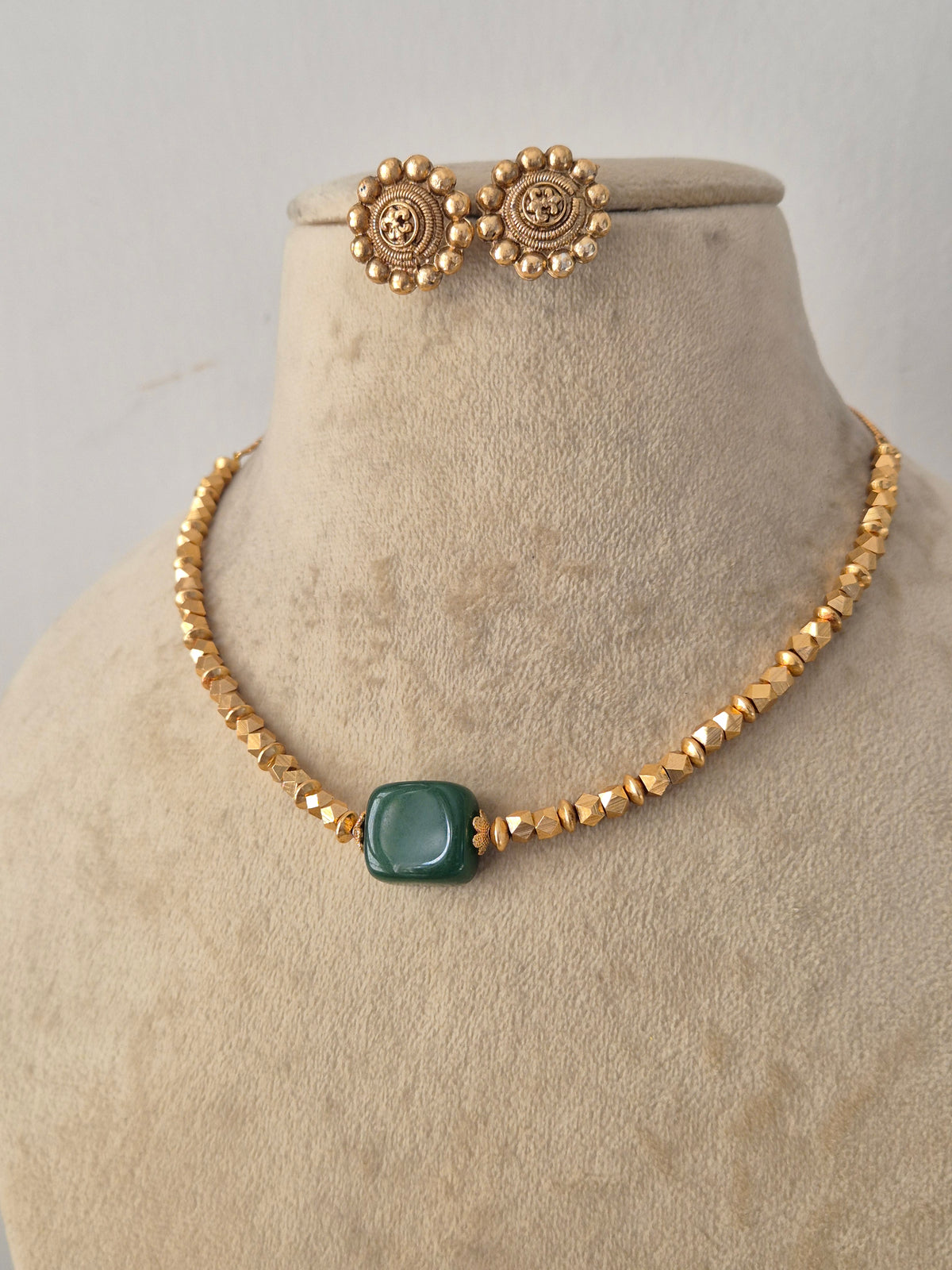 Handcrafted Brass Alloy Pendant Set with a polished finish, showcasing a clean geometric green gemstone design paired with classic matching studs for versatile everyday and festive wear by Naitri.in