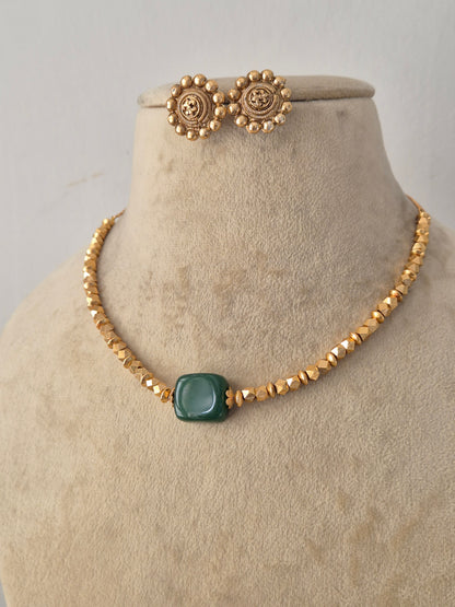 Handcrafted Brass Alloy Pendant Set with a polished finish, showcasing a clean geometric green gemstone design paired with classic matching studs for versatile everyday and festive wear by Naitri.in