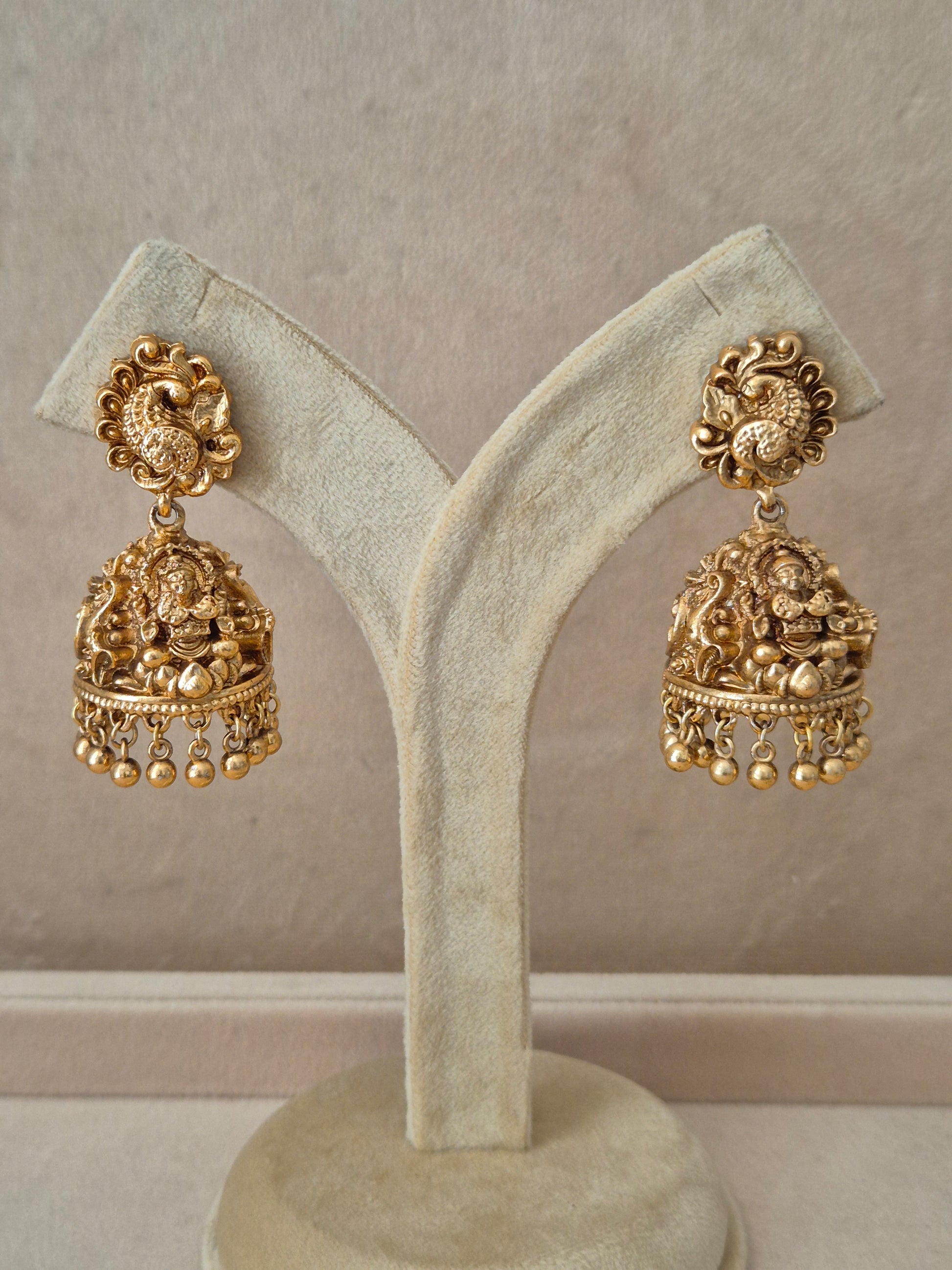 Traditional gold-toned festive earrings featuring clustered white seed pearls and delicate hanging pearl accent  by naitri.in
