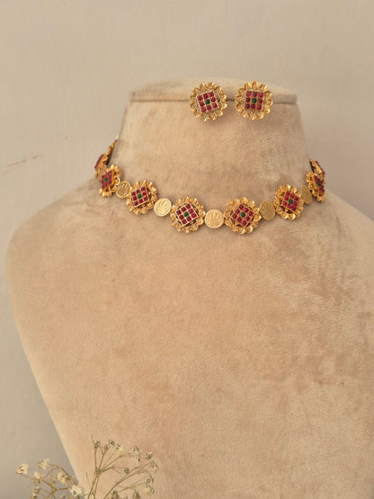 Festive gold-finish choker necklace set featuring circular floral motifs studded with red and green stones for wedding and ethnic wear by naitri.in