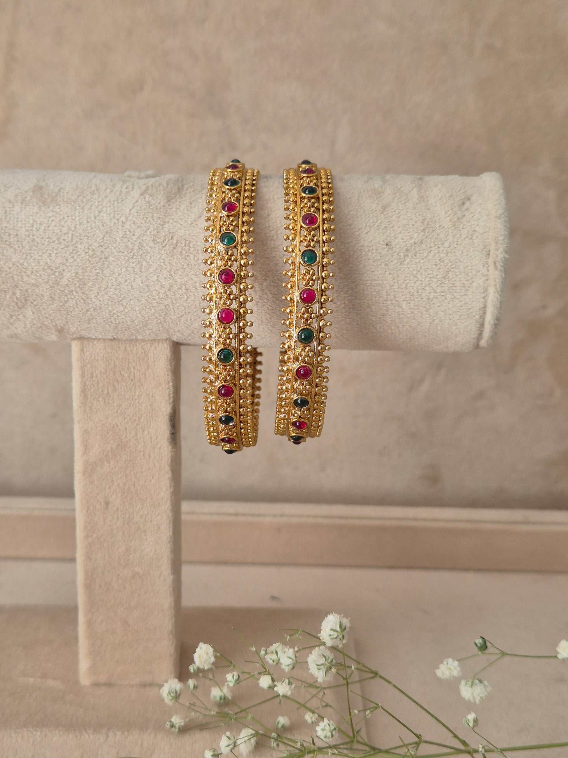 Set of 2 gold-toned bangles studded with vibrant red, green, gemstones, by naitri.in