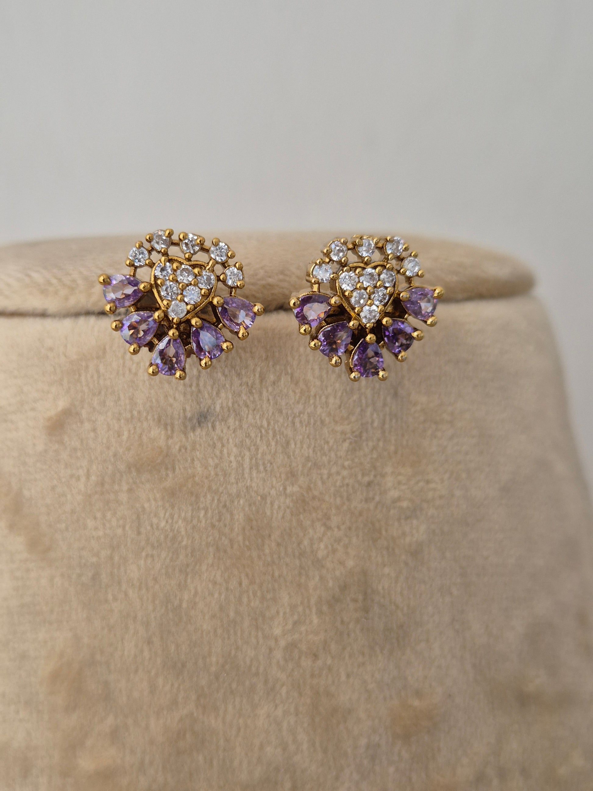 Minimalist gold-toned earrings featuring flower charms made of light purple gemstones and clear crystal centers, lavender floral earrings by naitri.in
