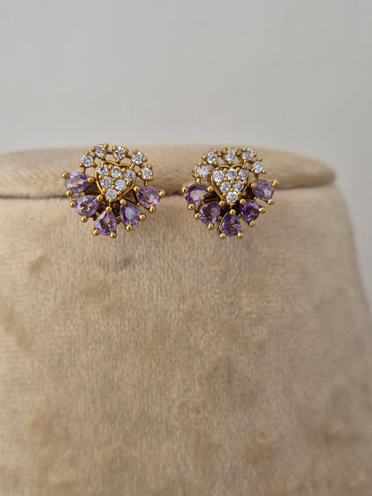 Minimalist gold-toned earrings featuring flower charms made of light purple gemstones and clear crystal centers, lavender floral earrings by naitri.in