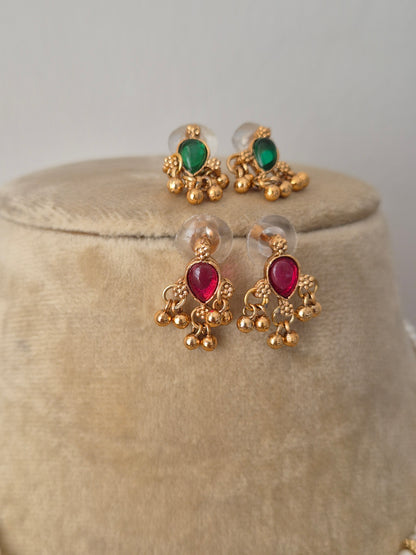 Gold-polished delicate studs with red-green  kemp stones embellishments