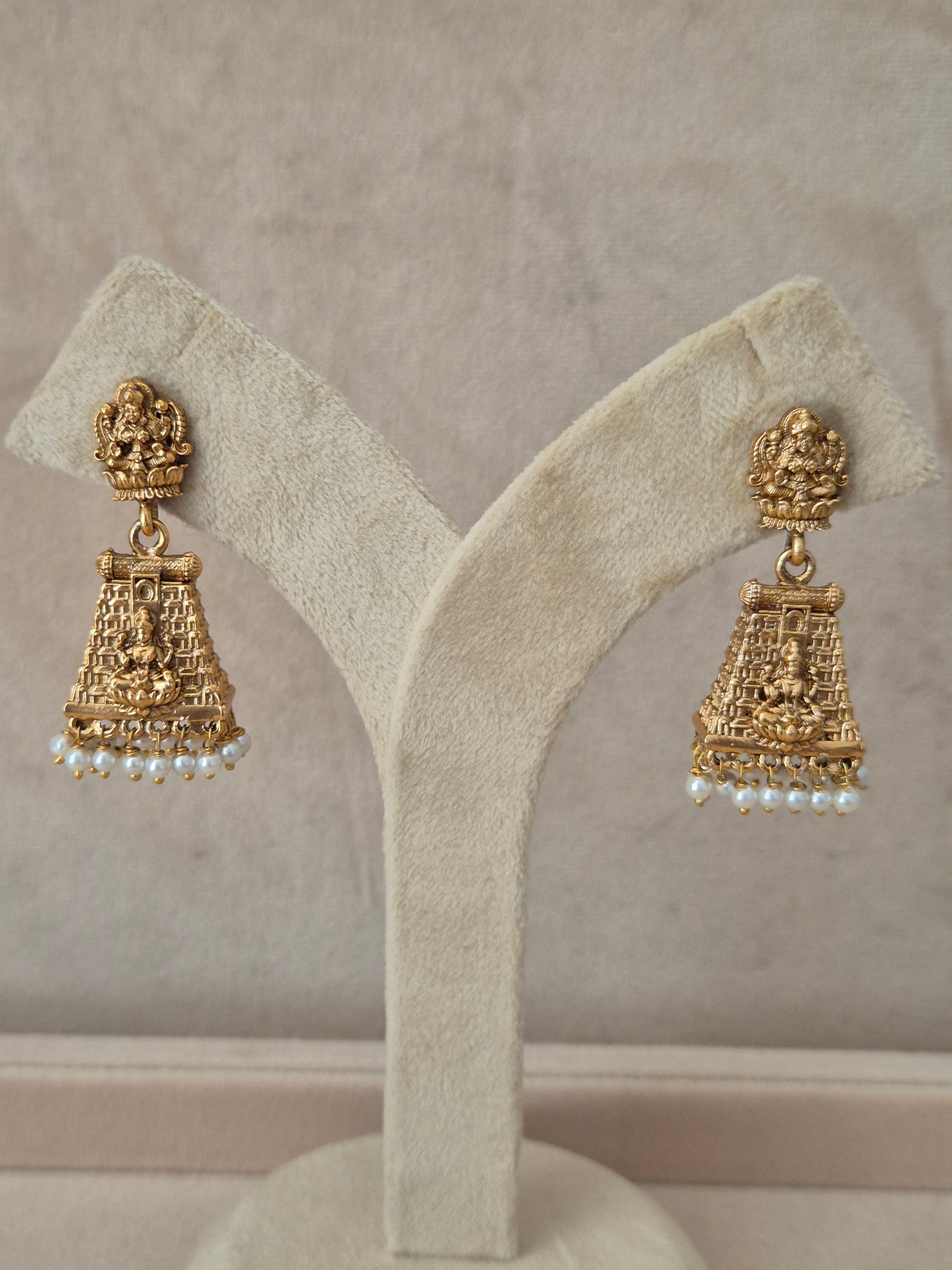 Traditional gold-plated temple earrings with tiered engraving and small white dangling pearls by naitri.in