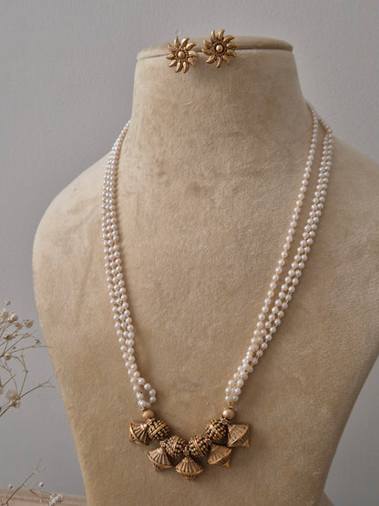 Handcrafted pearl strand necklace with golden jhumka drops and floral stud earrings by Naitri.in