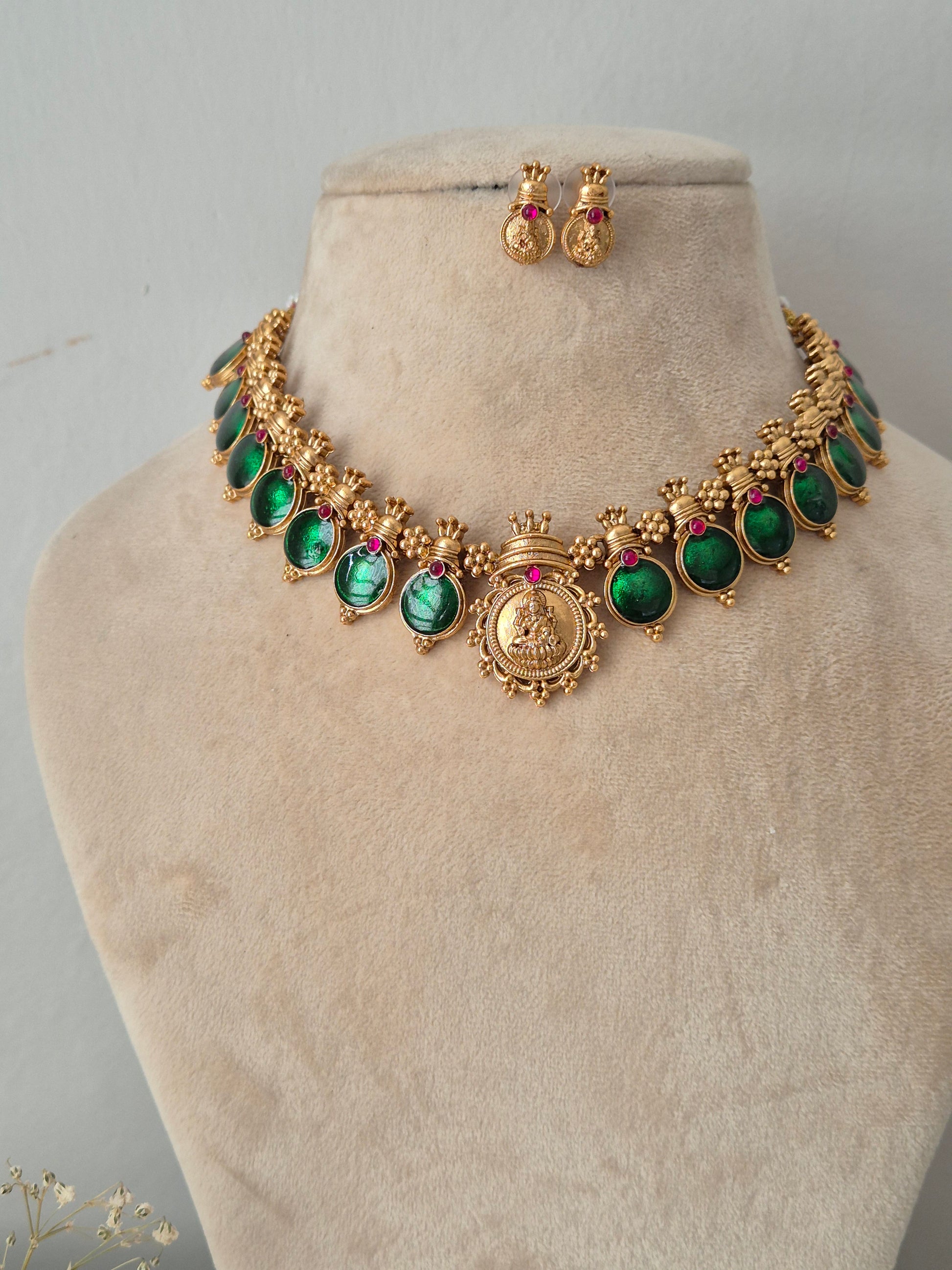 Gold-tone traditional Indian choker necklace and matching drop earrings with green oval stones and small pink accent stones, by naitri .in