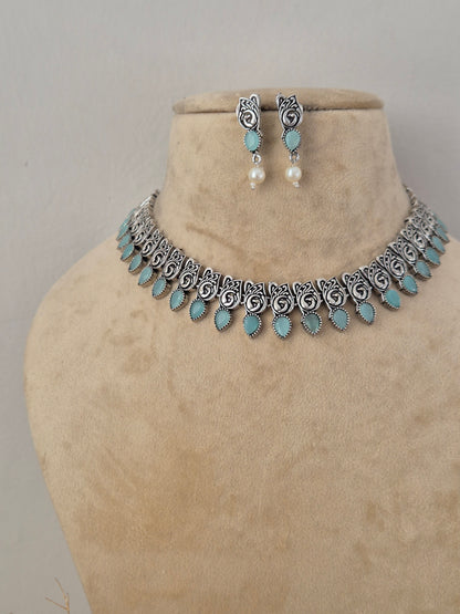 Boho-chic handcrafted silver-toned necklace set featuring vibrant turquoise embellishments and pearl drops for festive and ethnic wear by naitri.in