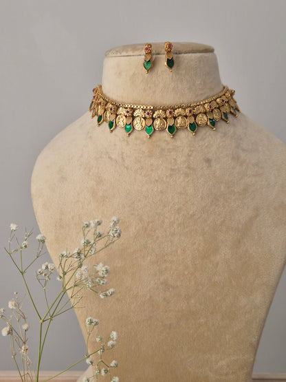 Handcrafted Julie Choker Set featuring a gold-polished brass necklace with green emerald-style stone drops and matching stud earrings by naitri.in