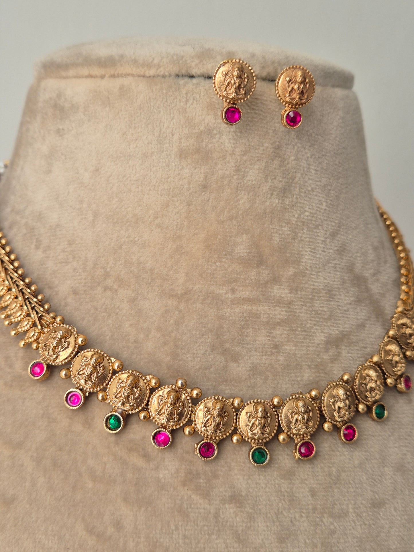 Gold necklace with colorful stones detailed goddess motifs, temple jewellery, divine sacred design by naitri.in