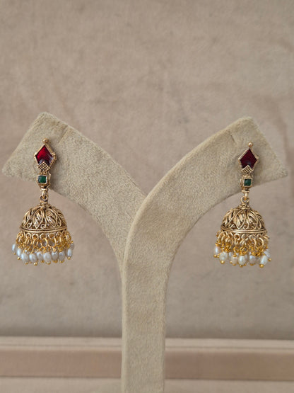 Traditional gold-plated Kalindi Jhumka earrings with red and green stones and small white dangling pearls by naitri.in