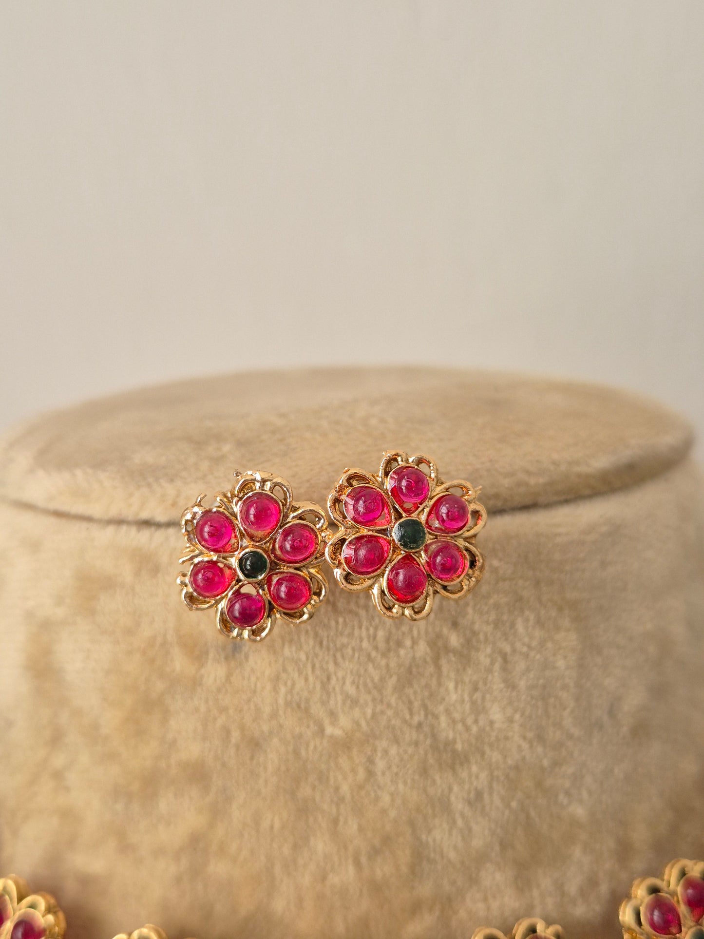 Gold-plated ethnic earring uby-pink gemstone flowers with green stone centers, by naitri.in
