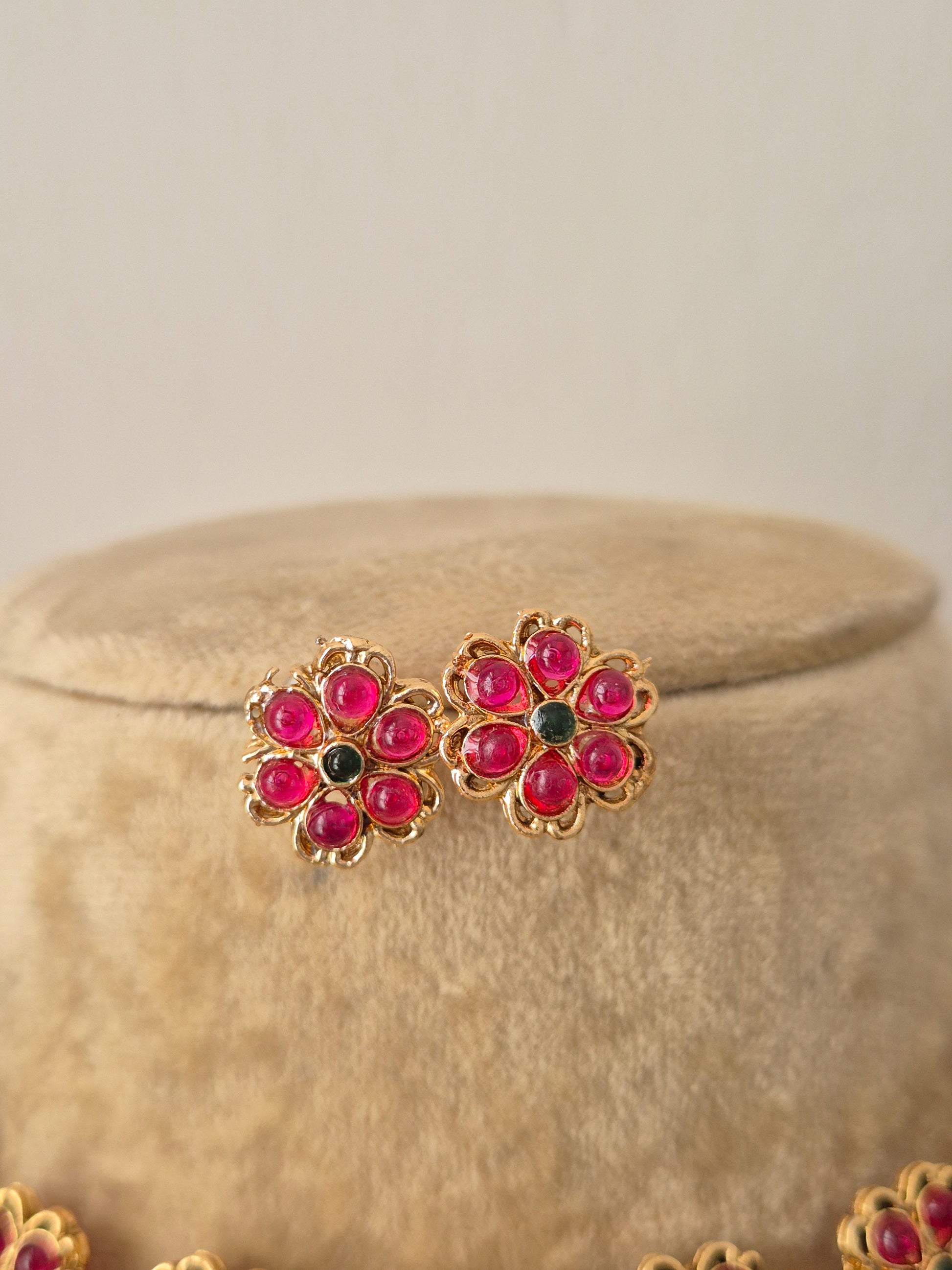 Gold-plated ethnic earring uby-pink gemstone flowers with green stone centers, by naitri.in