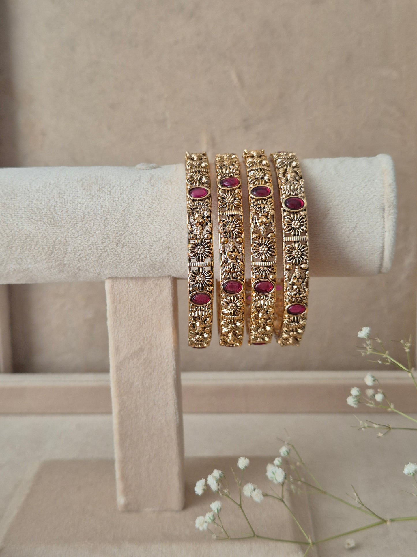 Set of gold bangles with red stones by naitri.in 