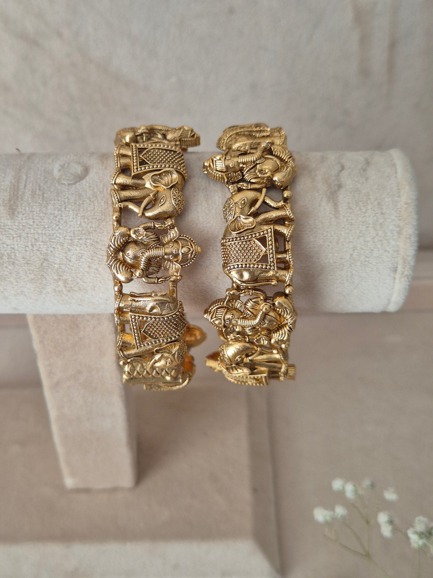 Set of two traditional gold-toned openable bangles with embossed elephant details By naitri.in