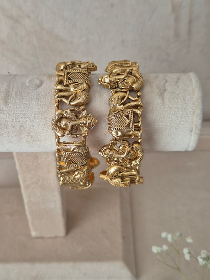 Set of two traditional gold-toned openable bangles with embossed elephant details By naitri.in