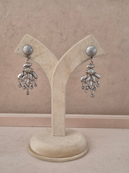 A pair of silver-toned dangle earrings Handcrafted silver-toned dangle earrings artisanal silver oxidized chandelier earrings with hanging bead accents by naitri.in