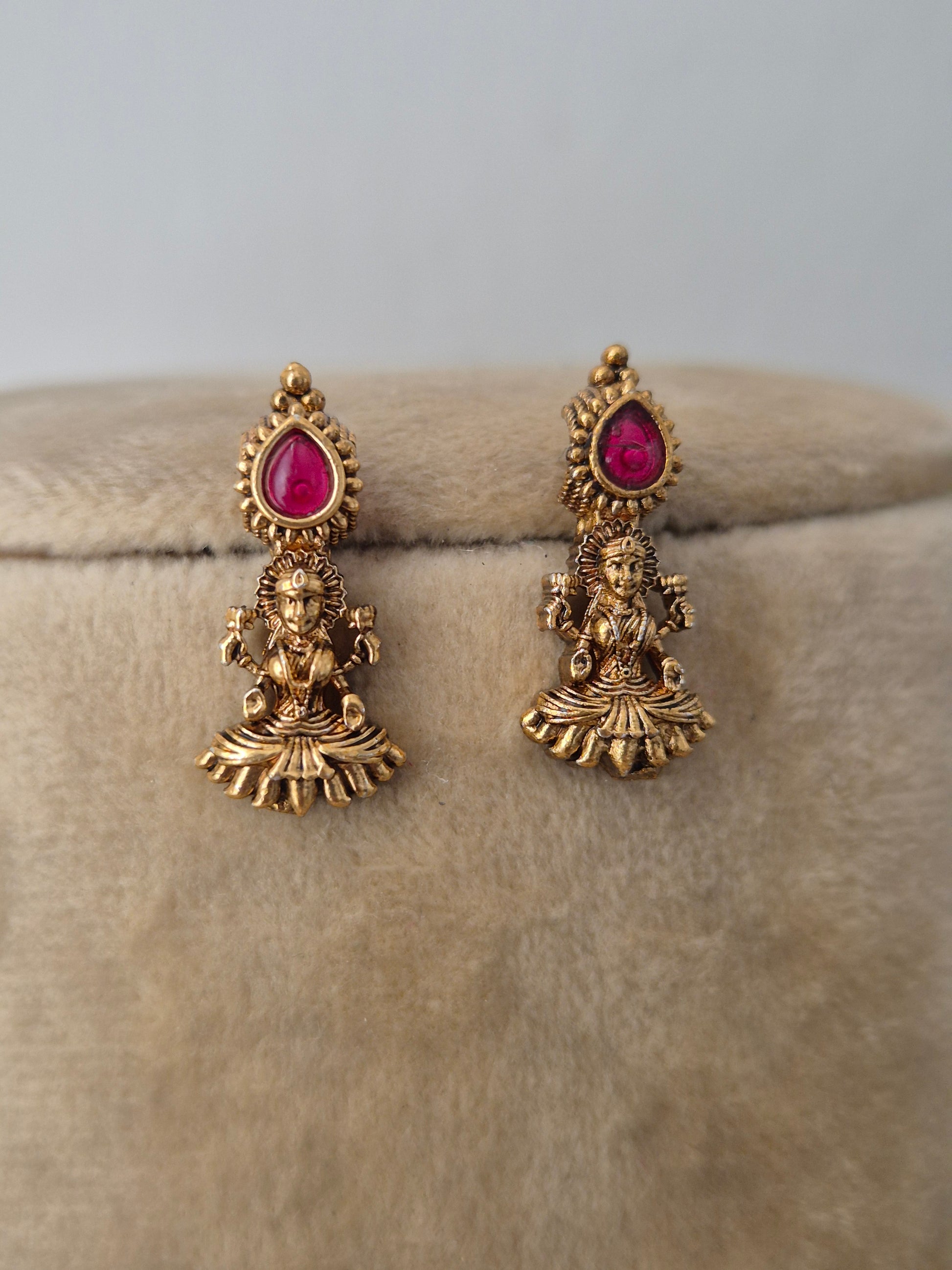 Antique gold-plated earring featuring delicate dangling pendants with tiny red  stone accents, by naitri.in