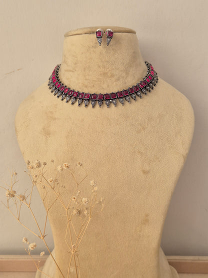 Kokila oxidized silver choker necklace set with ruby pink stones and matching earrings by naitri.in
