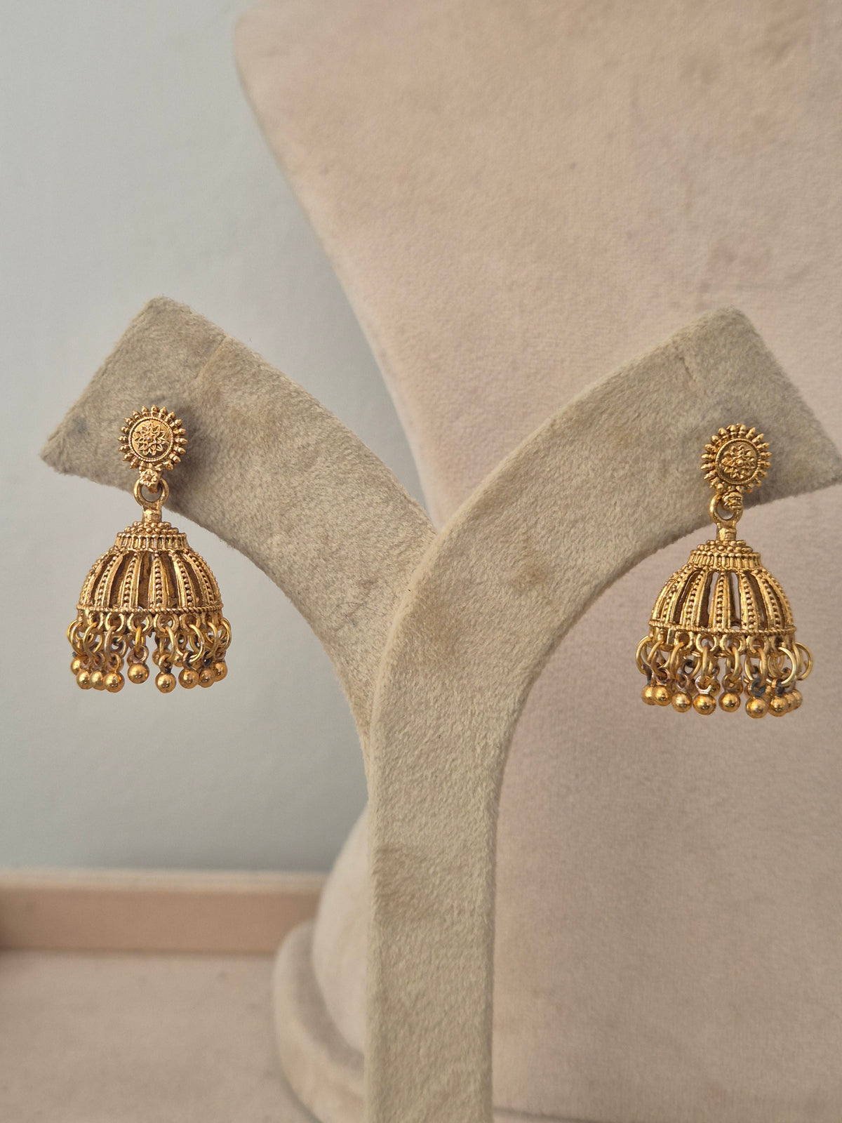 Gold antique bell-shaped earrings with small dangling beads by naitri.in