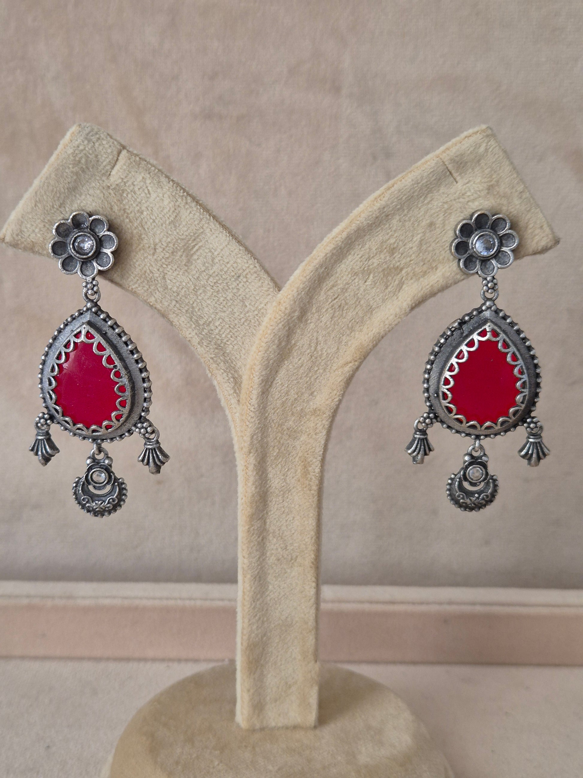 Naitri premium Kunti oxidized silver earrings with red gemstones from the Silver Jewellery collection, Handcrafted silver-toned floral stud and red drop earrings by naitri.in