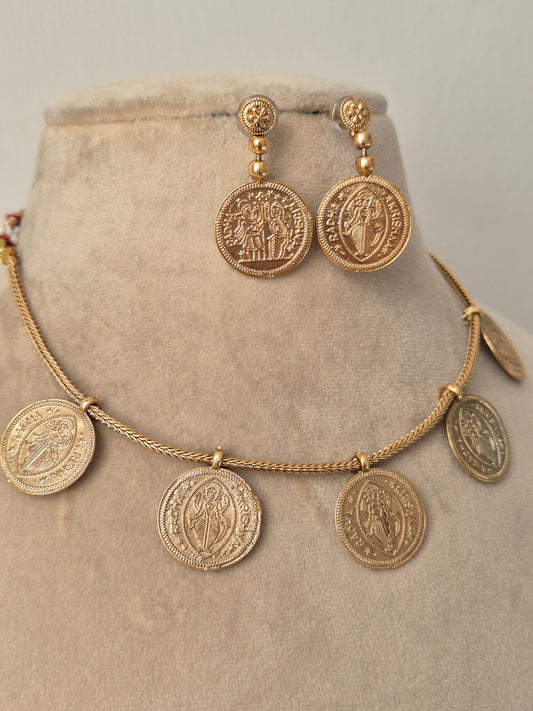 Vintage-style coin necklace with a double-sided embossed Radha-Krishna  motif, hanging from a delicate gold cable chain by naitri.in