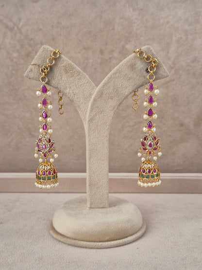 Lalima handcrafted gold-toned jhumka earrings with purple stones, white pearls, and green enamel accents by naitri.in