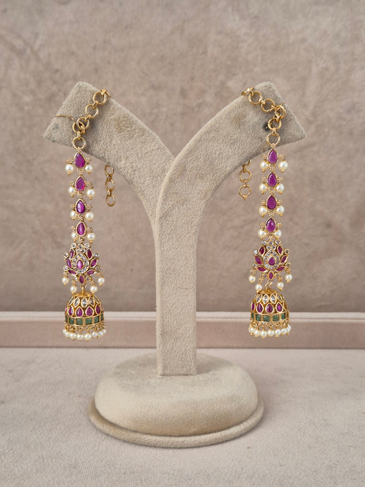 Lalima handcrafted gold-toned jhumka earrings with purple stones, white pearls, and green enamel accents by naitri.in