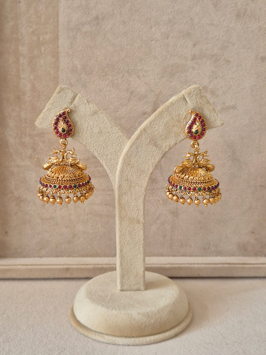 raditional gold-toned earring featuring mango-shaped (paisley) studs with red and green gemstones and intricate gold beadwork, by naitri.in