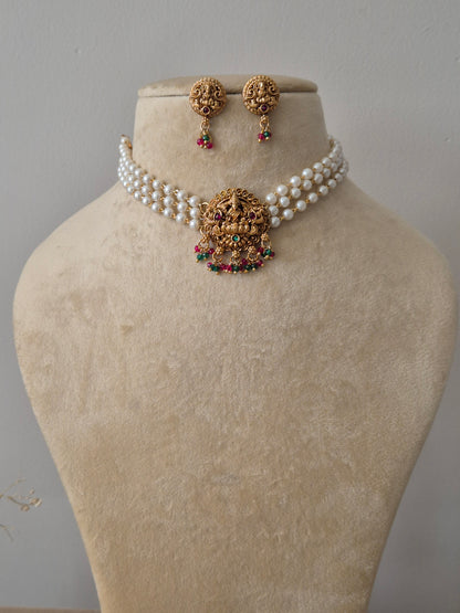 Set of gold jewelry with pearls chain, central motif representing purity and enlightenment, often used as a throne for the goddess by naitri.in