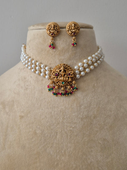 Goddess Lakshmi motif choker set with red and green kemp stones, intricate Nakshi carvings, and matching jhumka earrings by naitri.in